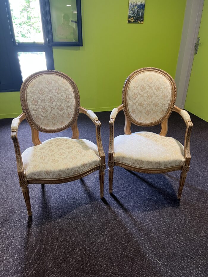 Paire de fauteuils de style Louis XVI en noyer massif rechampi et tapissé, chevillés