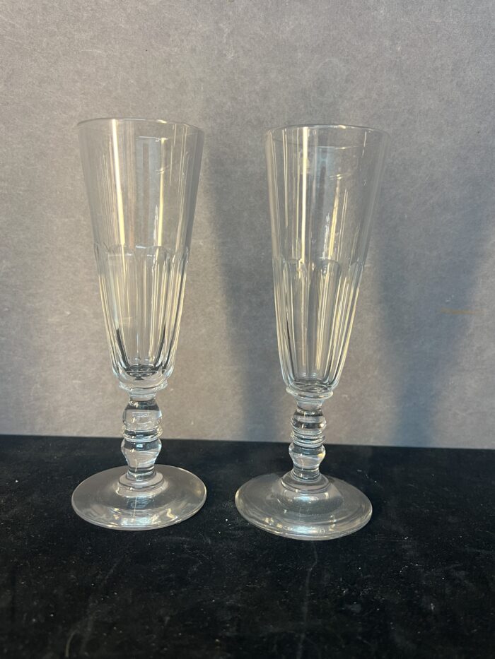 Série de sept flûtes à champagne en cristal taillé, héritées de l’époque Napoléon III.